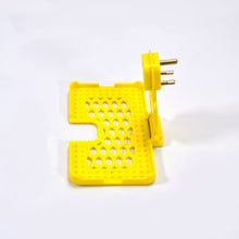 Wall-mounted mobile charging holder in yellow.